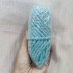 Hand holding blue polypropylene rope bundle