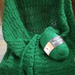 Green crocheted blanket and yarn.