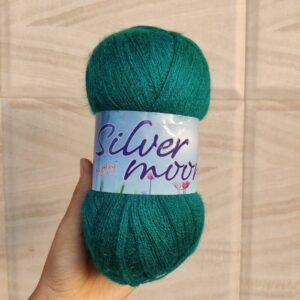 Green yarn skein with Silver Moon label.